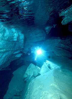 Diver at underwater cave entrance