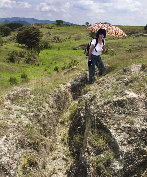 Susy Pint on natural "trail" between curved rock surfaces