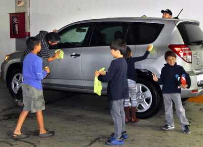 Kids from “Help the Children, Please!” wash cars without water. Photo courtesy of Help the Children, Please!